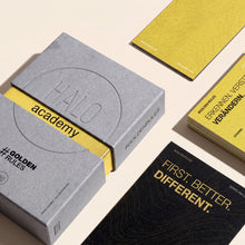 HALO GoldenRules Box liegend zwischen gelben und schwarzen Regelkarten
